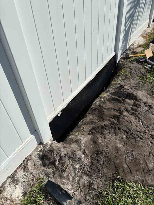 Installed HDPE as a water barrier under fence