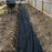 Drainage fabric in a narrow side yard drainage trench

