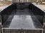 HDPE dump trailer liner installed in a solid-side dump trailer at a construction site
