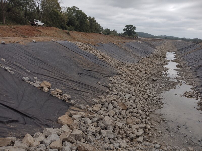 Geotextile fabric under a rock-lined erosion control channel
