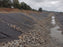 Geotextile fabric under a rock-lined erosion control channel
