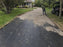 Raking gravel over gravel driveway fabric on a residential driveway
