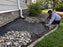 Heavy-duty weed barrier under a river rock landscape bed
