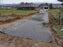 Non-woven geotextile fabric laid over subgrade before gravel is dumped for a driveway base
