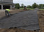 Non-woven geotextile fabric laid as a road base separator on a rural farm driveway
