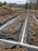 Non-woven geotextile fabric lining gravel trenches for a septic drain field near a rural home

