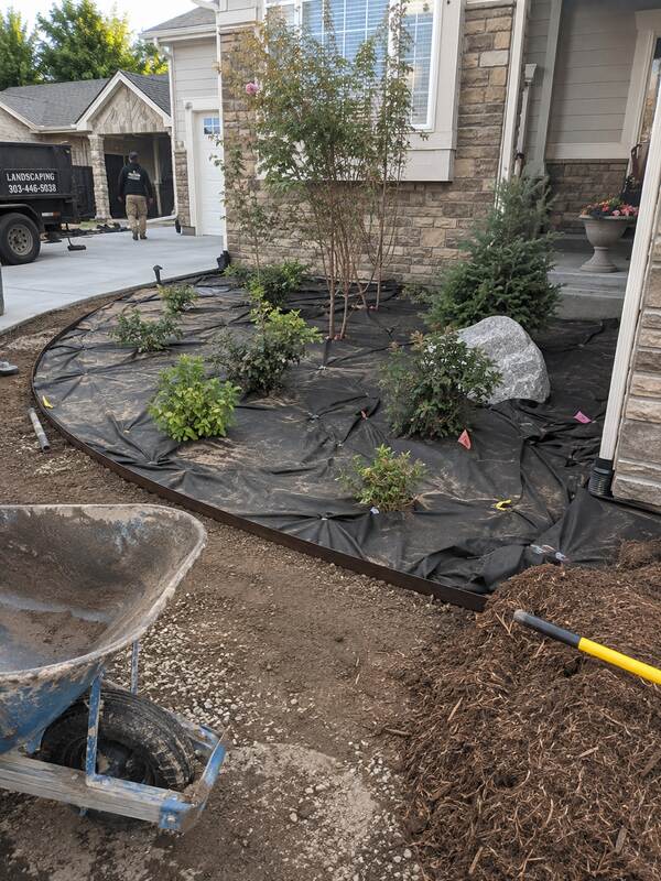 Non-woven geotextile fabric used as a weed barrier under mulch in a landscaped planting bed
