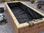 Non-woven raised bed liner fabric fitted inside a wood planter box on a gravel patio

