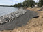 Non-woven geotextile fabric under riprap for lakeside shoreline reinforcement
