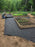 Rolling out polyspun landscape fabric in a garden
