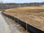 Silt fence fabric on wood stakes
